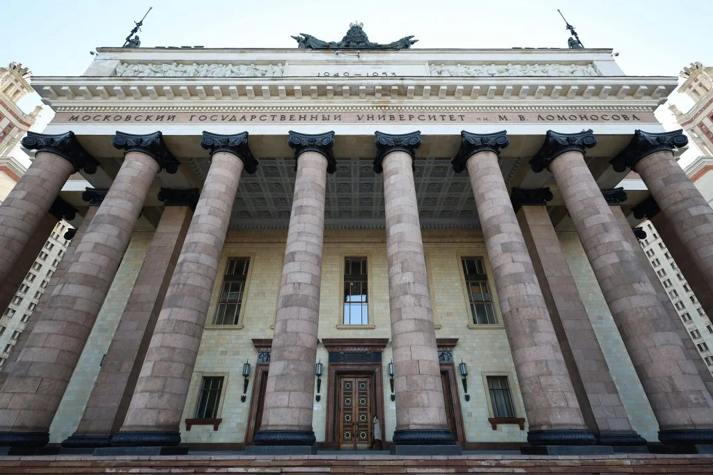 Majestic facade of Moscow State University with imposing columns in daylight.